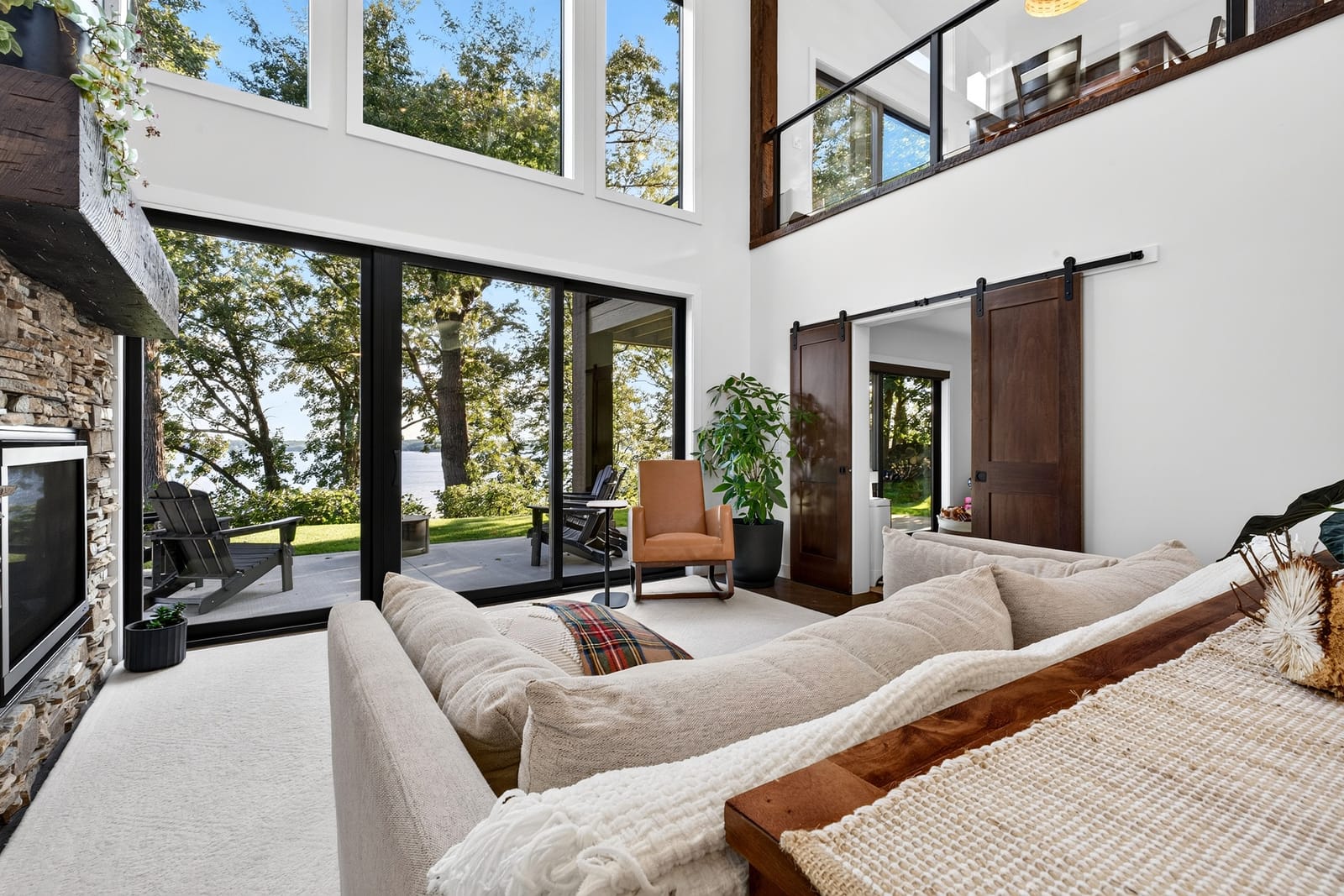 The great room, with the lake-side wall of glass seen from inside.