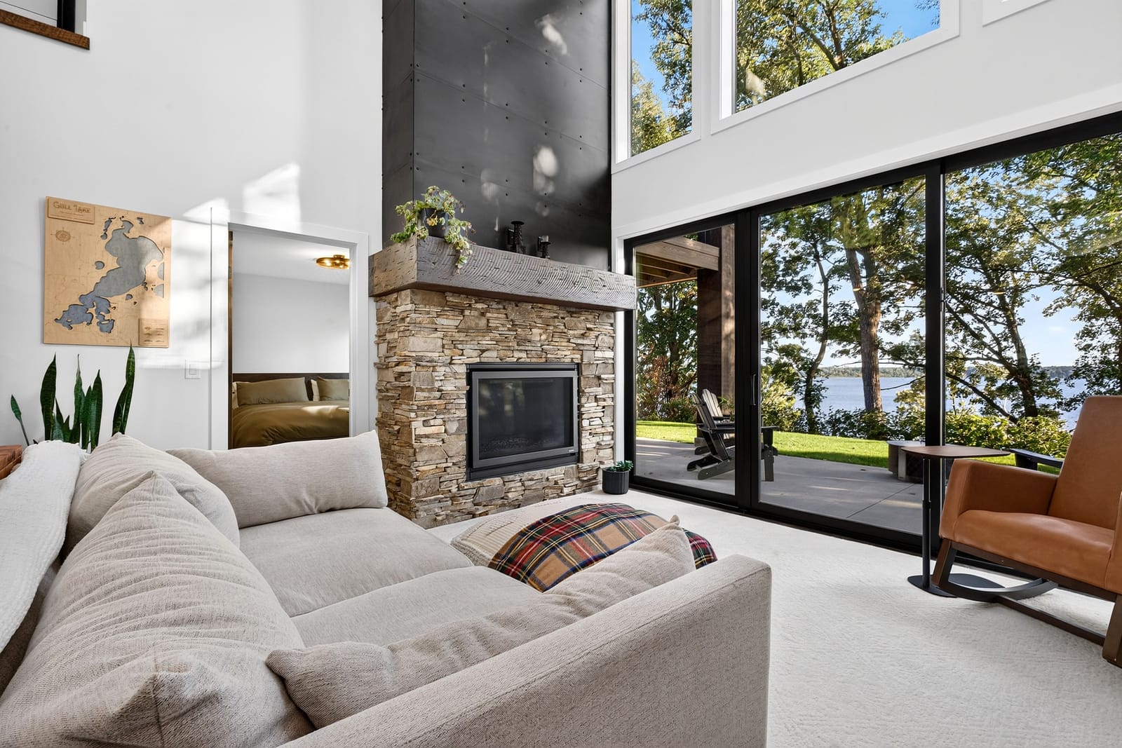The stone fireplace and the wall of glass, with the loft above.