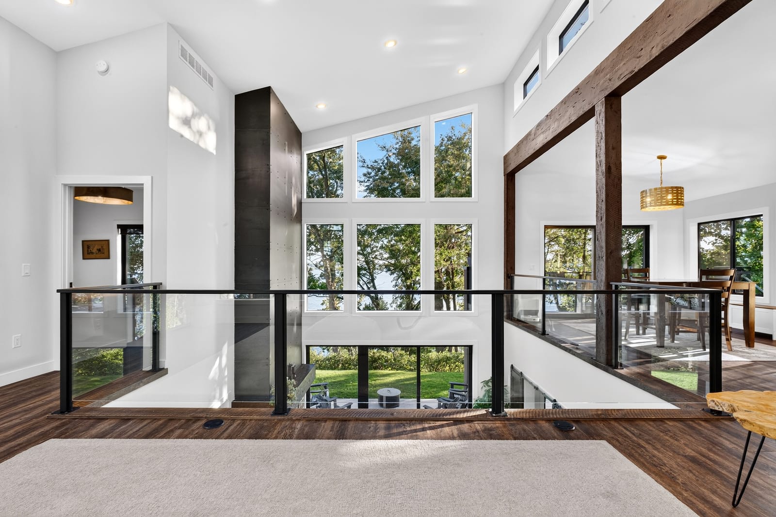 The loft landing behind black-framed glass railings.