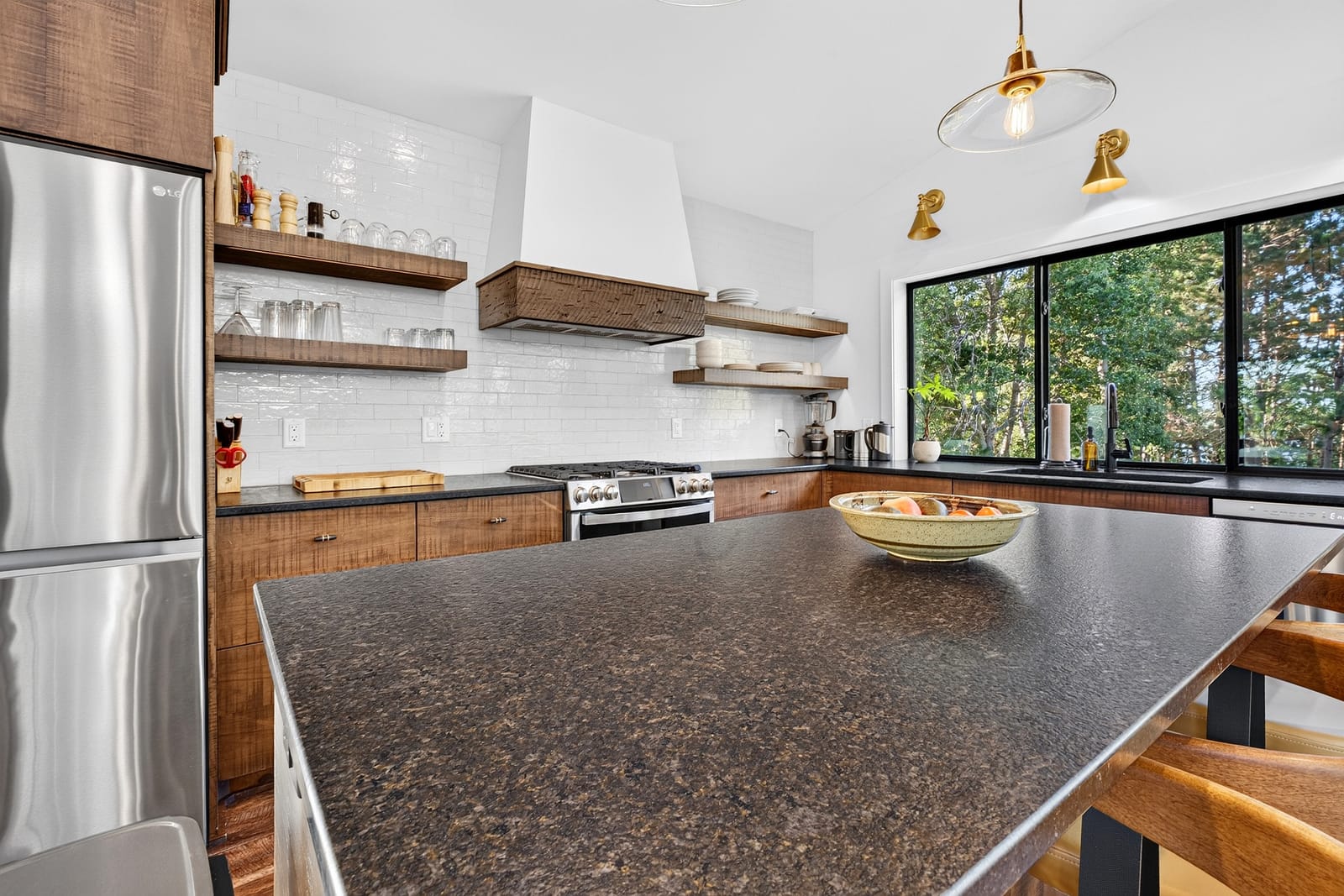 The range wall, with open timber shelving above the tile.