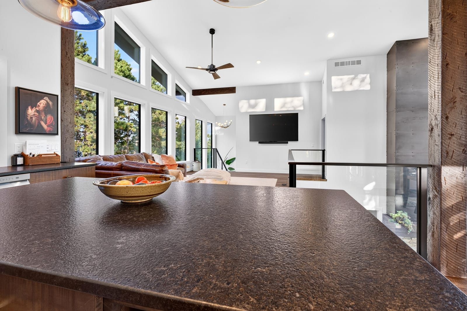 Across the island to the living room and the windows beyond.