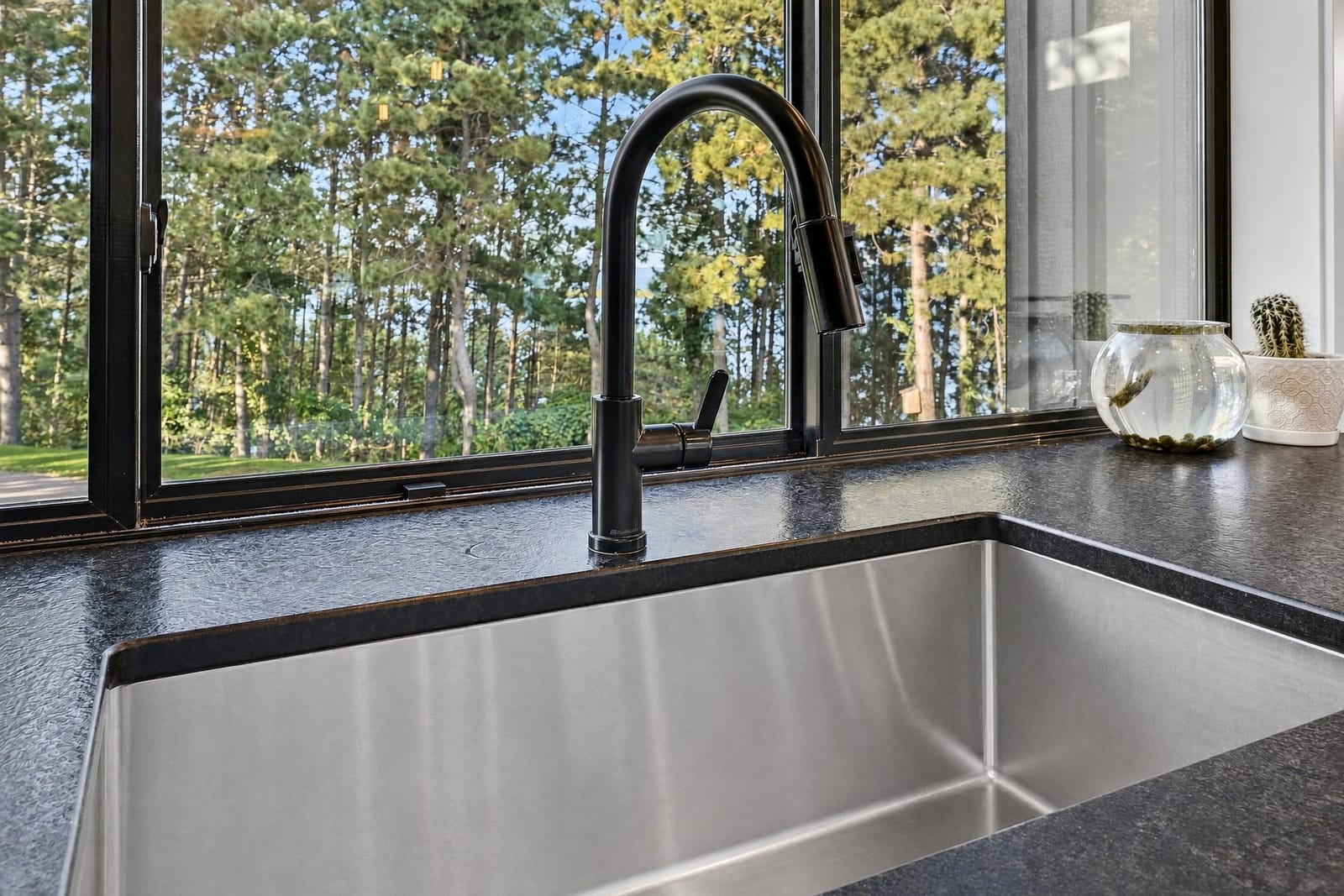 The sink set under a window into the pines.