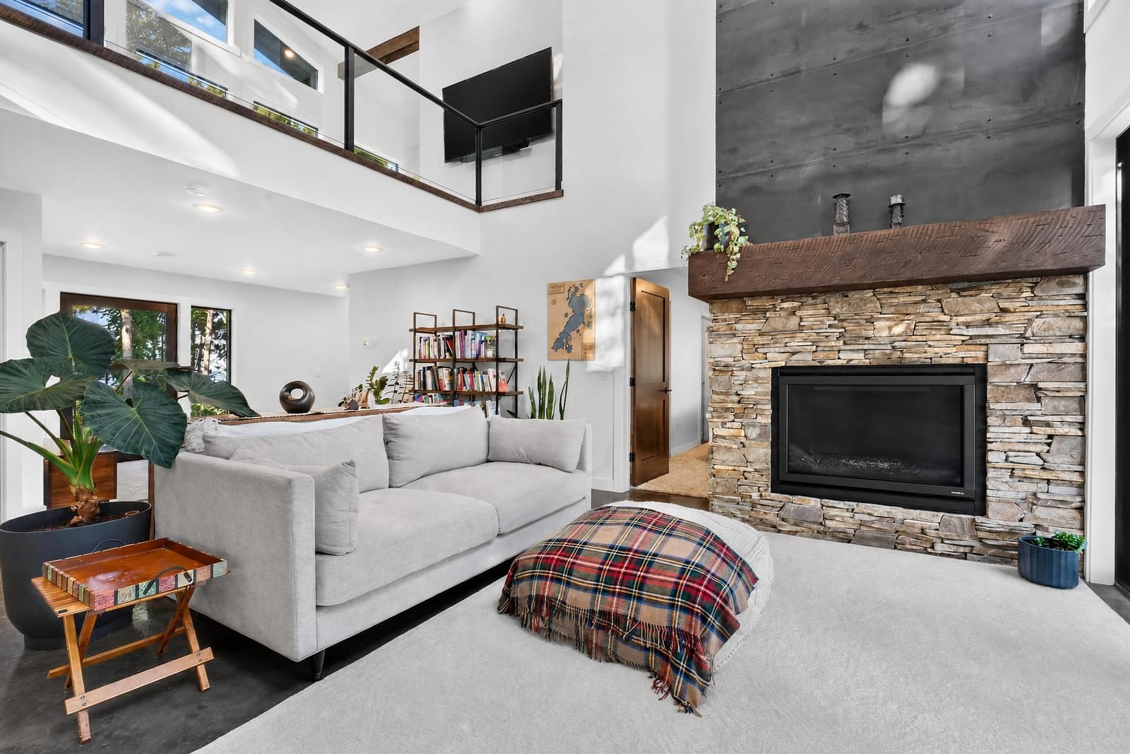A suite with its own stone fireplace and a loft above.