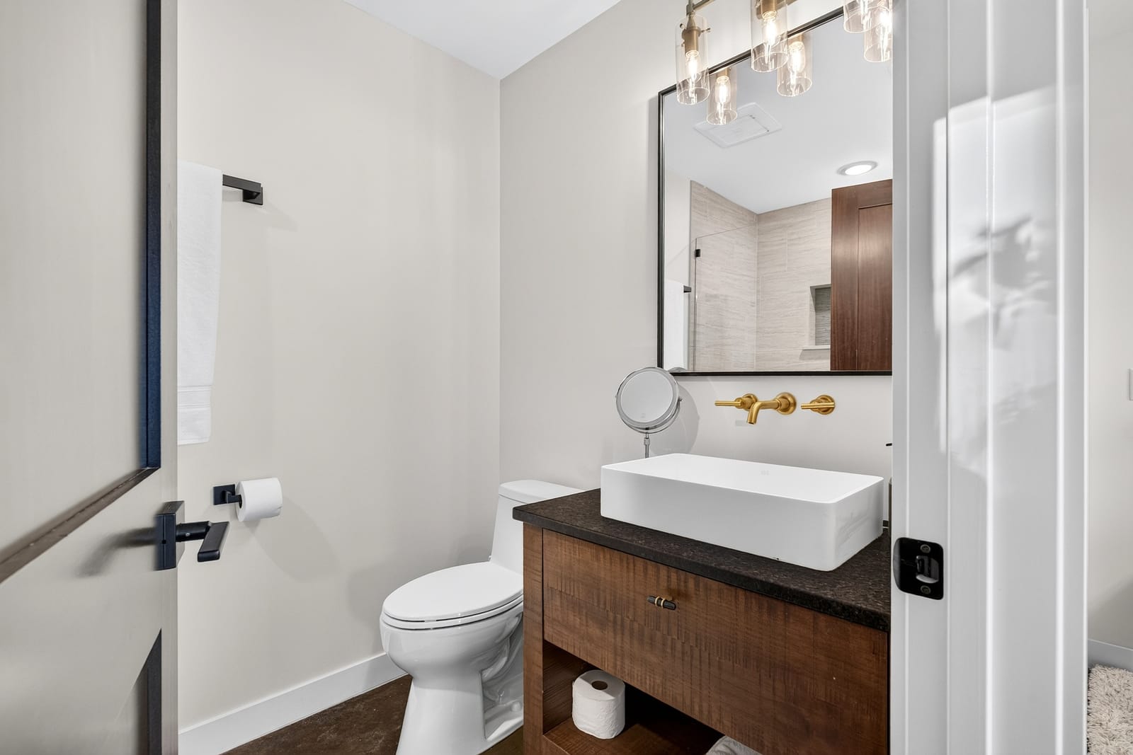 A second bathroom vanity under brass fittings.